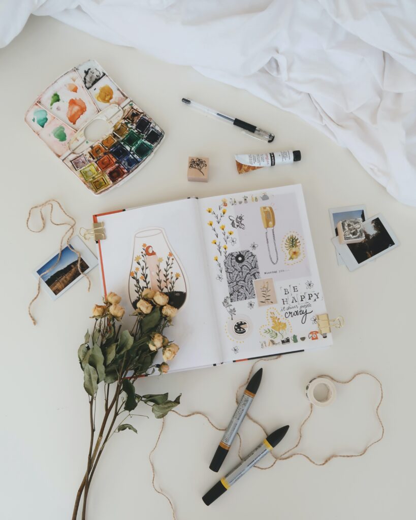 Paint, dried flowers, art pens, collage, Polaroid prints, and ink stamps provide the elements for creativity.